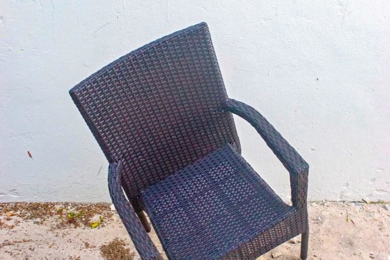 A simple chair positioned on the ground, showcasing its design and structure.